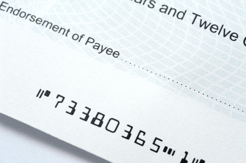 MICR encoded line on printed check showing E13B font characters